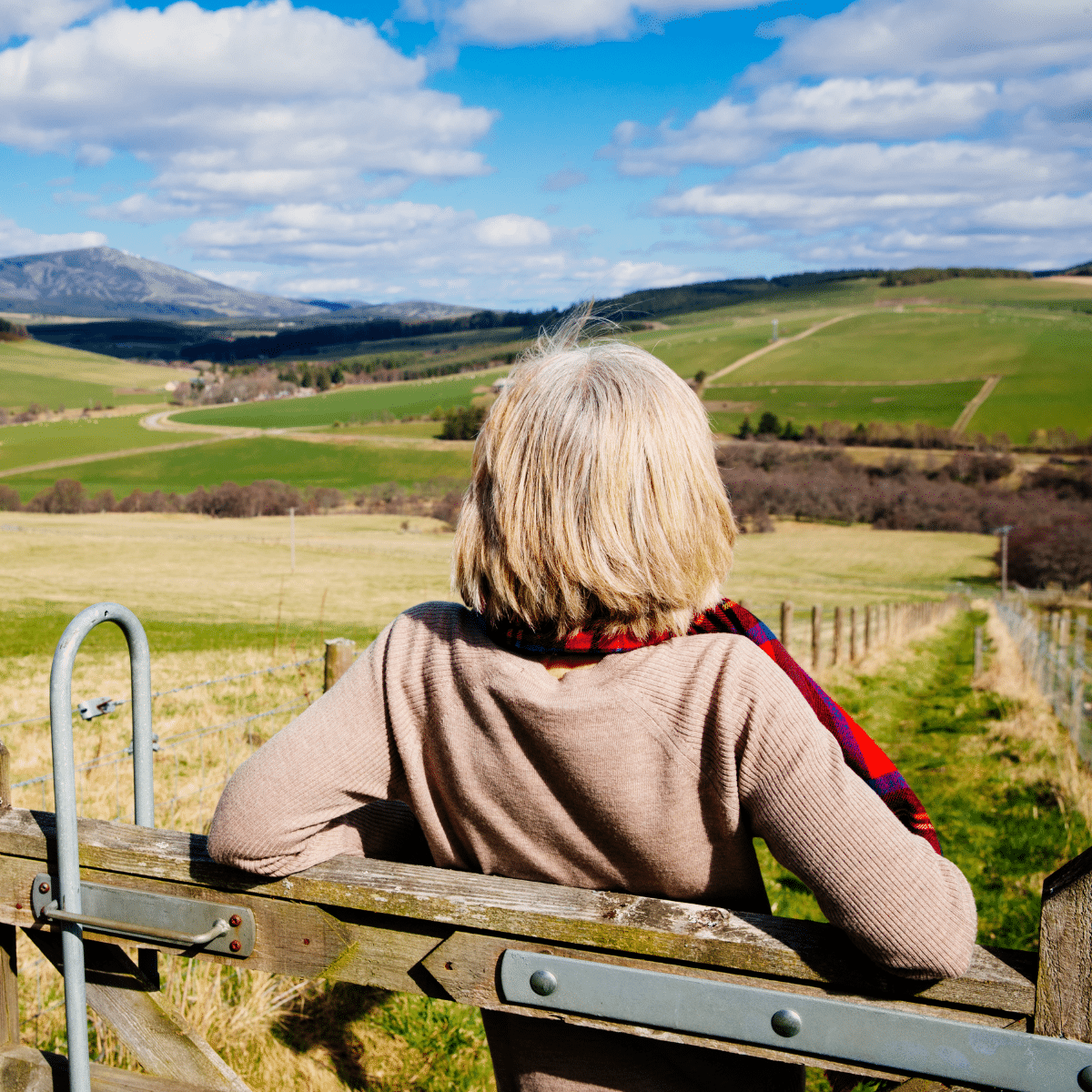 Woman leaning on fence