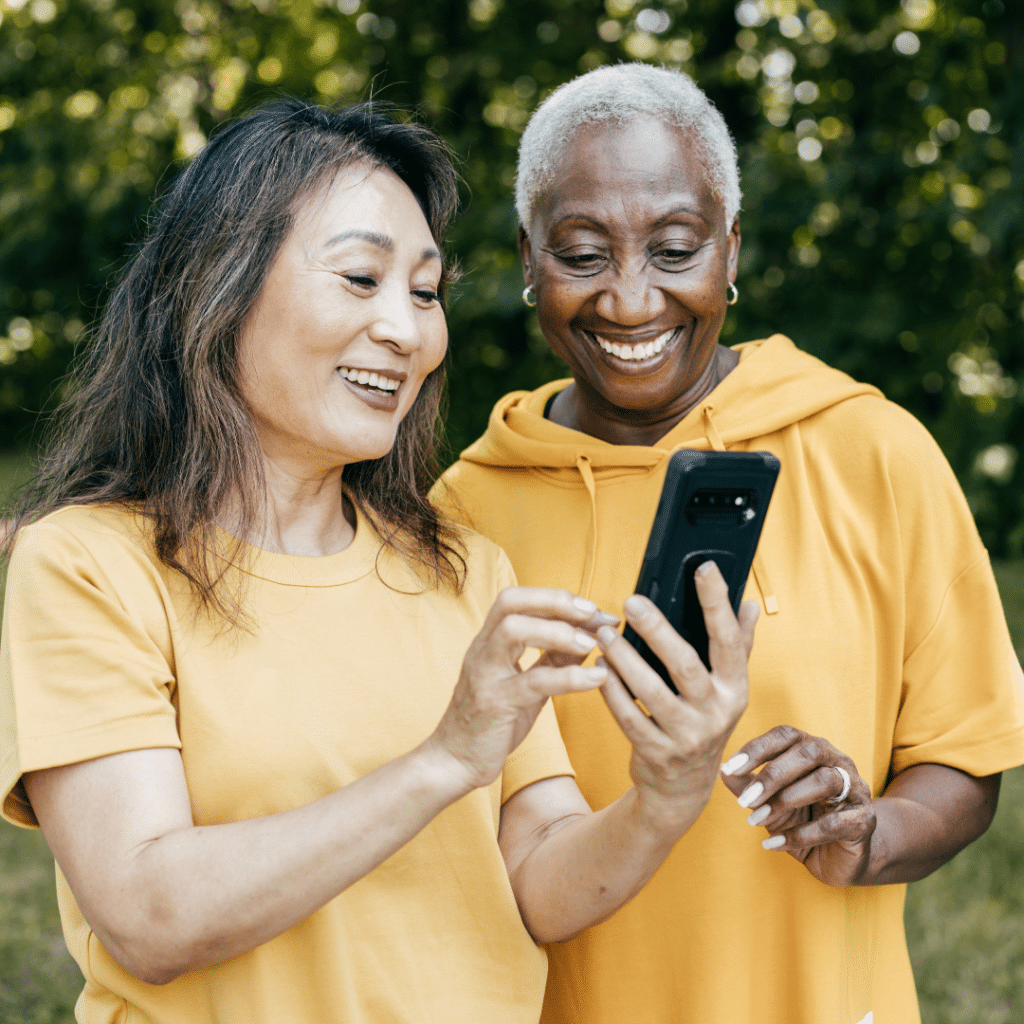 Two women reviewing info on a mobile phone