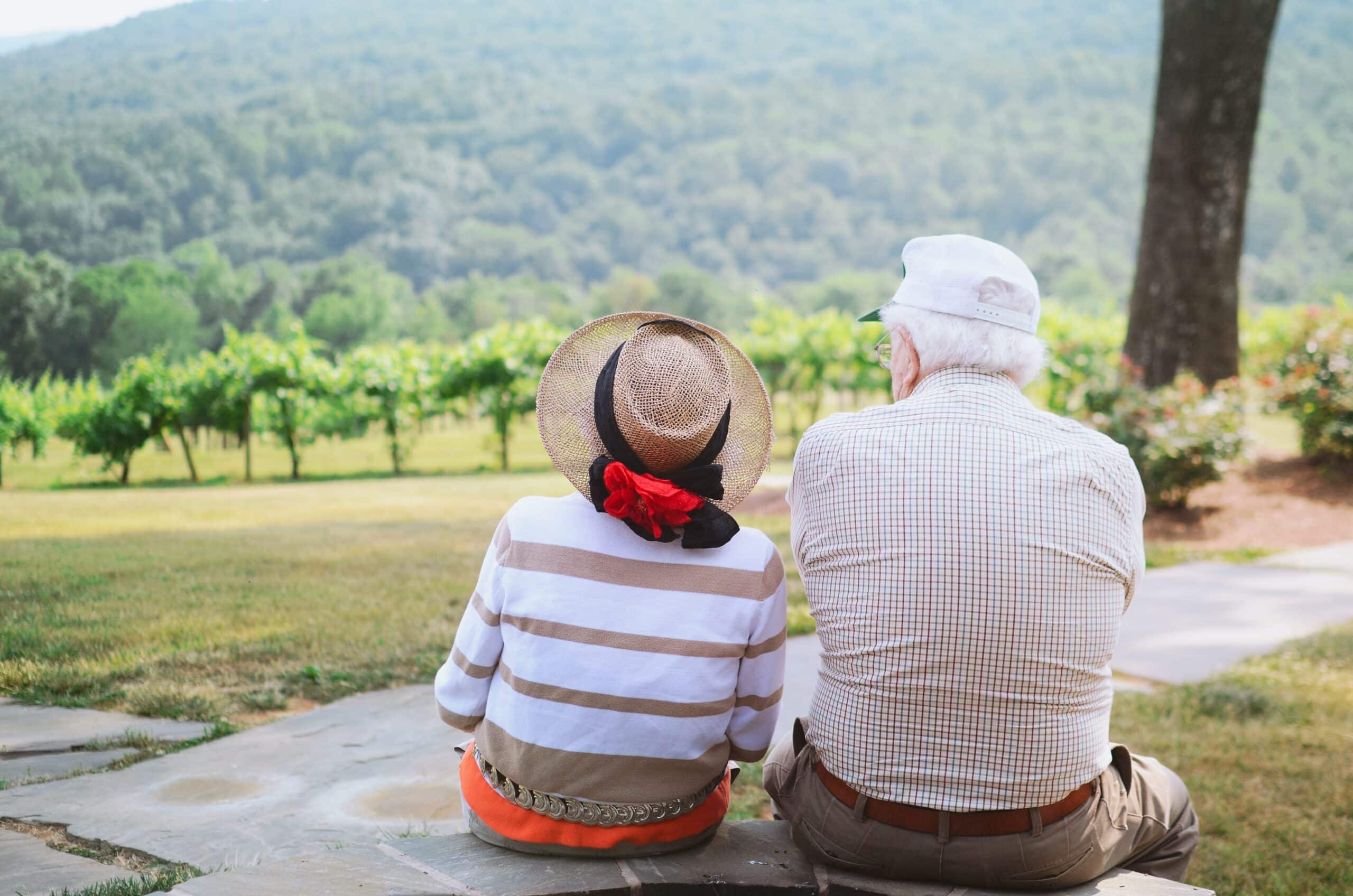 Couple sitting in a vineyard.